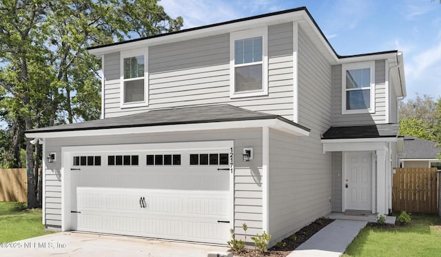 12171 Calais St, Jacksonville, FL 32224 - traditional-style home with a garage, roof with shingles, concrete driveway, and fence