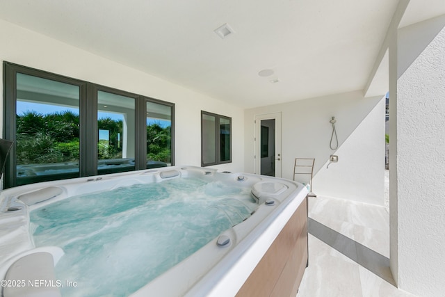 view of patio / terrace featuring a hot tub and french doors