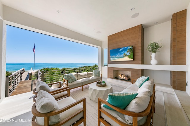 interior space with an outdoor hangout area and a water view
