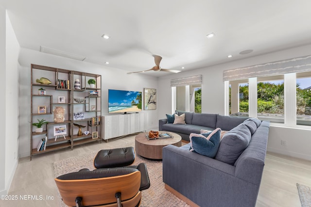 living area featuring light wood-style floors, baseboards, a ceiling fan, and recessed lighting