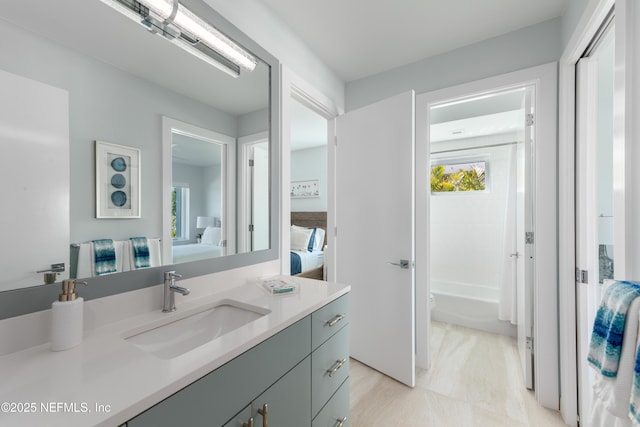 bathroom featuring vanity, ensuite bathroom, and shower / bathtub combination