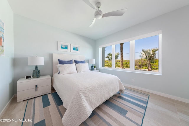 bedroom featuring baseboards and ceiling fan
