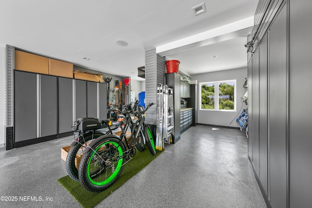 garage with baseboards and visible vents