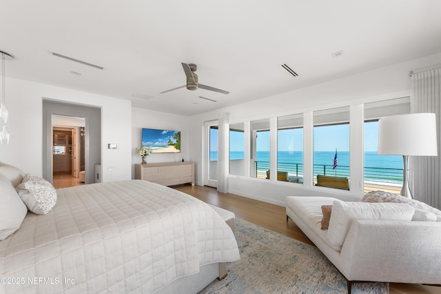 bedroom with baseboards, ceiling fan, and wood finished floors