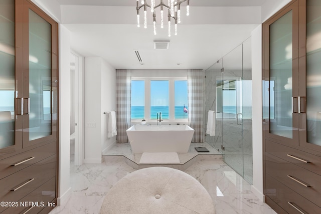 full bath featuring a freestanding bath, a stall shower, and marble finish floor