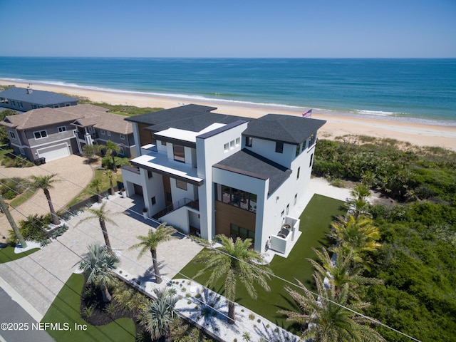 drone / aerial view featuring a water view and a view of the beach