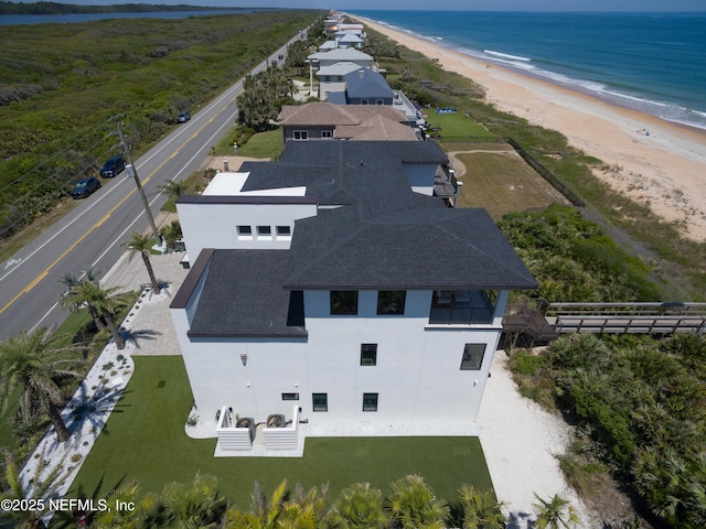 birds eye view of property with a beach view and a water view