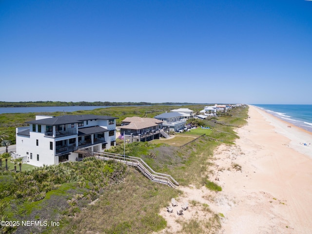 birds eye view of property with a water view and a view of the beach