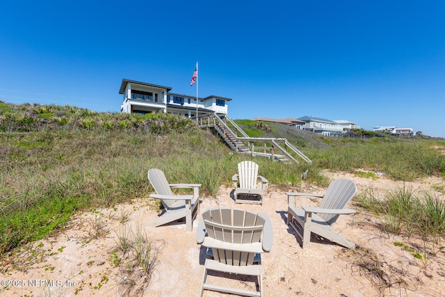 view of yard with stairway and an outdoor fire pit