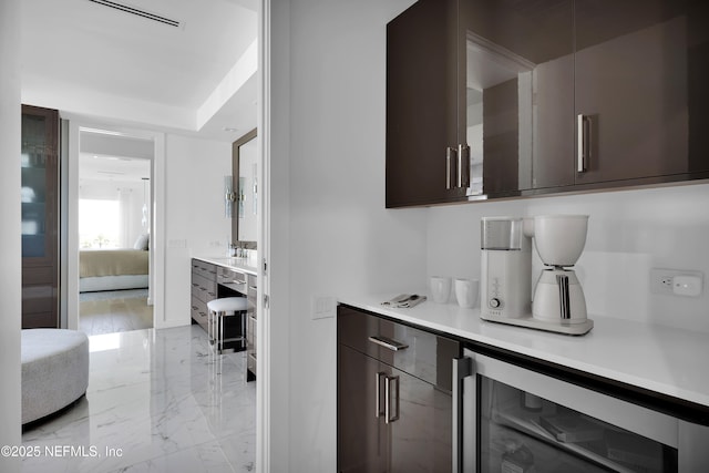 bar featuring visible vents, marble finish floor, and wine cooler