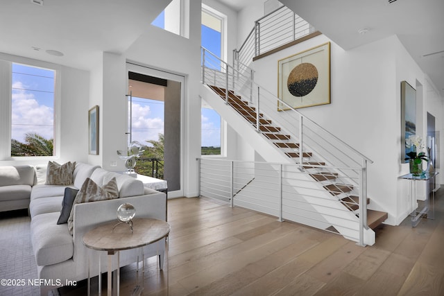 living room with wood-type flooring and stairs