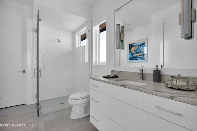 bathroom with vanity, tile patterned floors, a stall shower, and toilet