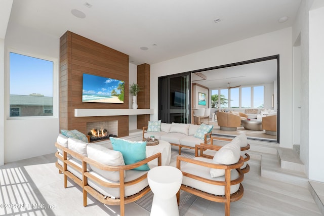 view of patio / terrace with an outdoor living space with a fireplace