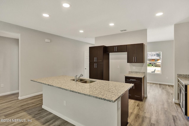 4375 Loys Dr, Jacksonville, FL 32246 - kitchen with baseboards, light wood-style floors, a sink, and dark brown cabinets