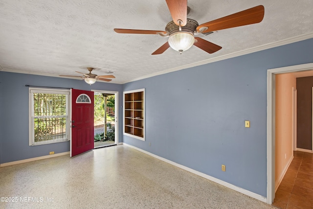 spare room featuring a textured ceiling, built in shelves, ceiling fan, baseboards, and ornamental molding