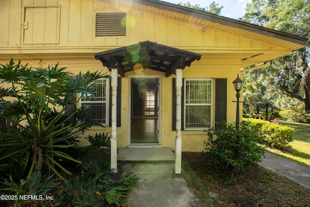 doorway to property featuring board and batten siding