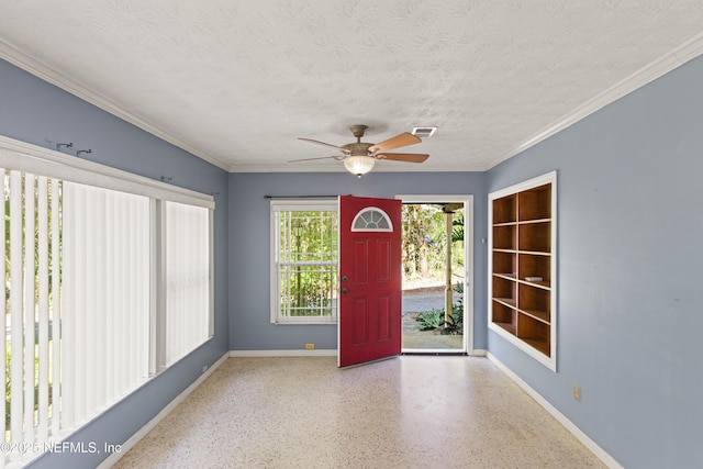 entrance foyer featuring a textured ceiling, visible vents, baseboards, speckled floor, and a ceiling fan