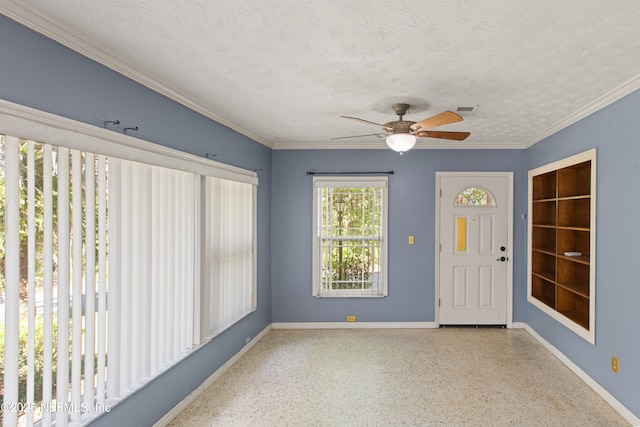 interior space with speckled floor, visible vents, baseboards, and ceiling fan
