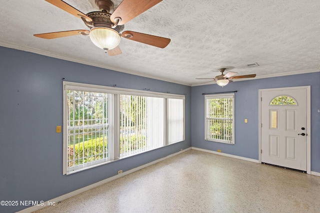 interior space with a ceiling fan, baseboards, a textured ceiling, and speckled floor