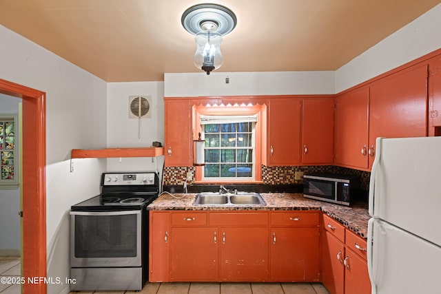 kitchen with plenty of natural light, appliances with stainless steel finishes, decorative backsplash, and a sink