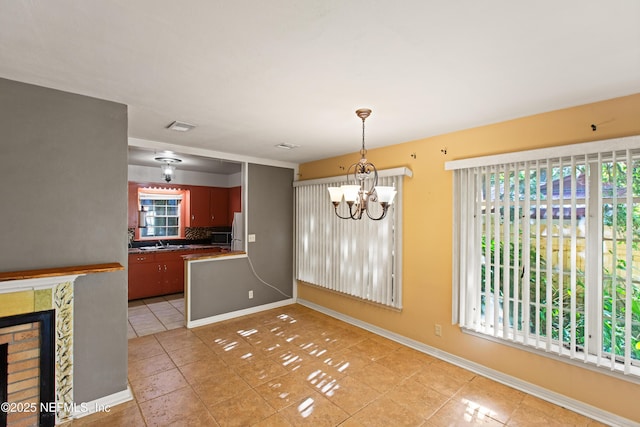 unfurnished dining area featuring light tile patterned floors, baseboards, a chandelier, and plenty of natural light