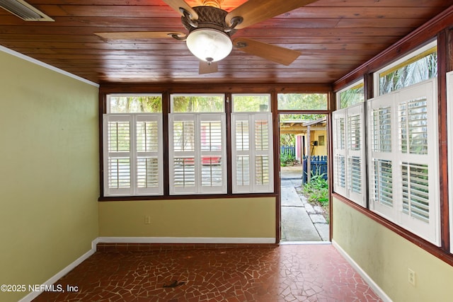 unfurnished sunroom featuring wood ceiling and baseboards