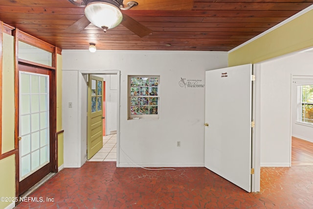 spare room with wood ceiling, baseboards, and ornamental molding
