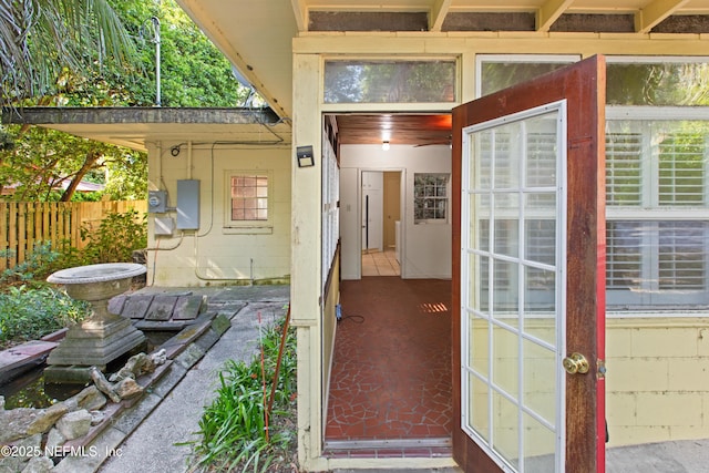 property entrance with fence and electric panel