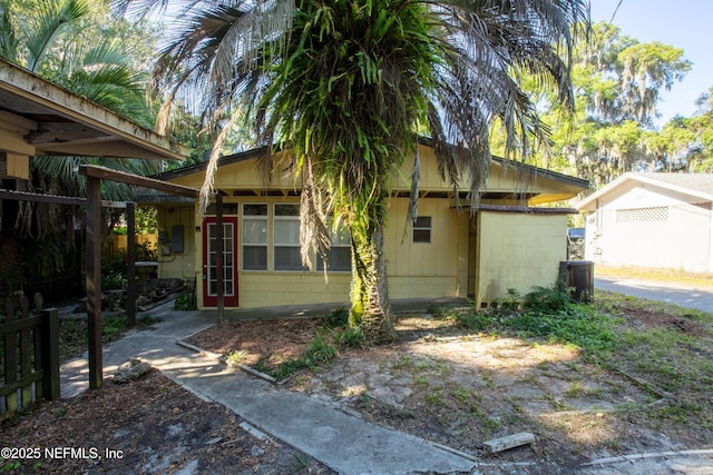 view of home's exterior featuring fence and concrete block siding