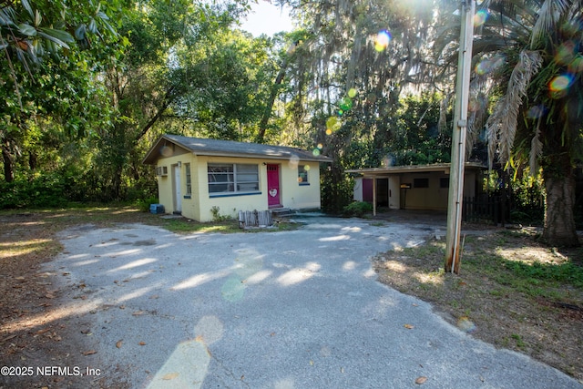 view of front of property with driveway and a carport