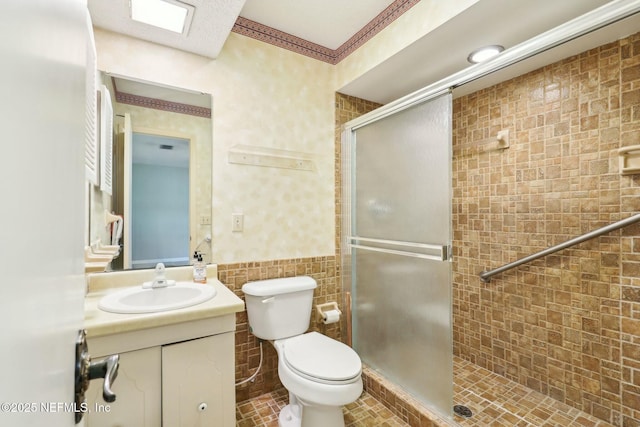 2815 Sylvan Ln S, Jacksonville, FL 32257 - bathroom featuring a shower stall, toilet, vanity, and tile walls