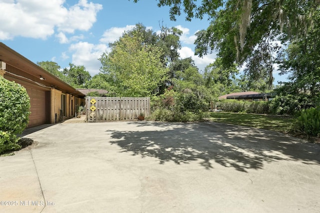 2815 Sylvan Ln S, Jacksonville, FL 32257 - view of patio / terrace featuring fence, driveway, and a garage