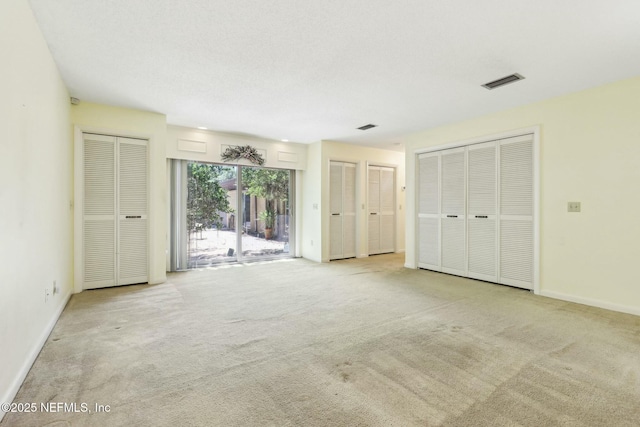 2815 Sylvan Ln S, Jacksonville, FL 32257 - unfurnished bedroom featuring baseboards, visible vents, access to outside, multiple closets, and carpet floors