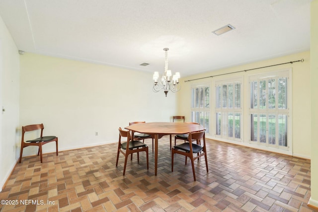 2815 Sylvan Ln S, Jacksonville, FL 32257 - dining room with baseboards, visible vents, and an inviting chandelier