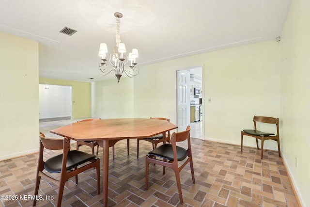 2815 Sylvan Ln S, Jacksonville, FL 32257 - dining space with baseboards, brick floor, a chandelier, and visible vents