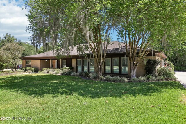 2815 Sylvan Ln S, Jacksonville, FL 32257 - view of front of property with a front yard and concrete driveway