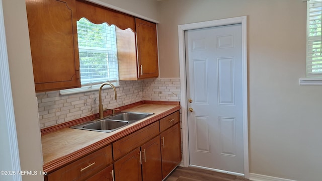 1919 W 5th St, Jacksonville, FL 32209 - kitchen featuring wood finished floors, a sink, brown cabinets, and tasteful backsplash