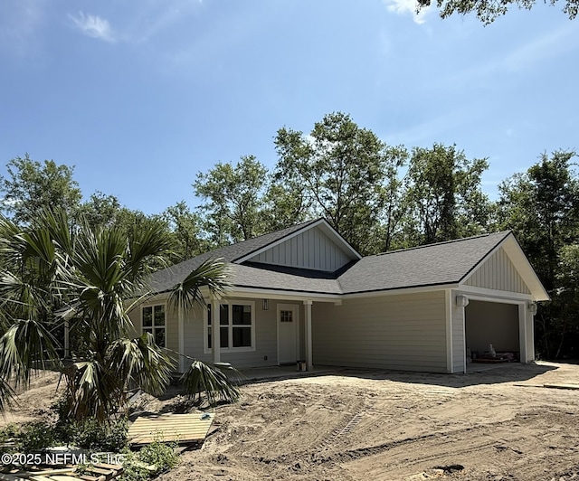 6333 Fox Hollow Ct, Hampton, FL 32044 - view of front of home with board and batten siding, an attached garage, and dirt driveway