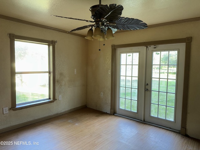 unfurnished room featuring a ceiling fan, crown molding, and a healthy amount of sunlight