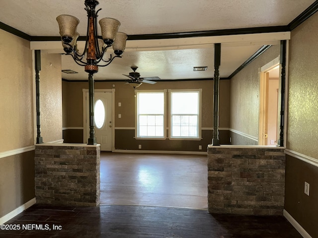 entryway with wood-type flooring, a textured wall, and a textured ceiling