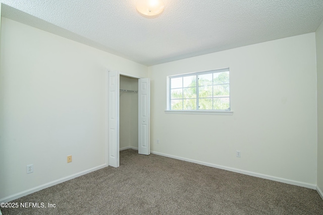 2631 Tuscany Glen Dr, Orange Park, FL 32065 - unfurnished bedroom featuring a textured ceiling, baseboards, carpet, and a closet