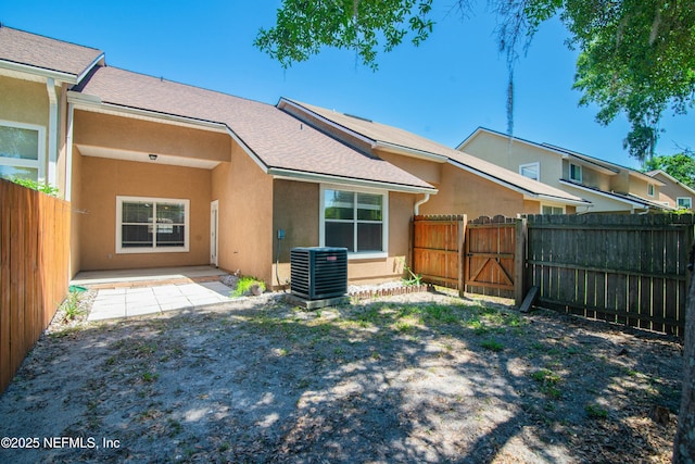 2631 Tuscany Glen Dr, Orange Park, FL 32065 - back of property featuring stucco siding, central AC unit, and a fenced backyard