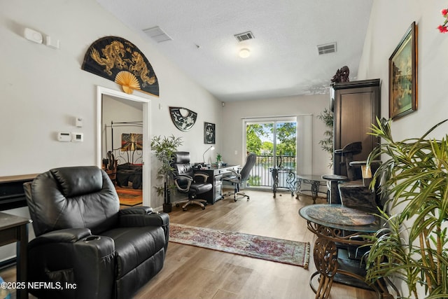 3671 Kirkpatrick Cir Unit 14, Jacksonville, FL 32210 - living room featuring lofted ceiling, visible vents, and wood finished floors