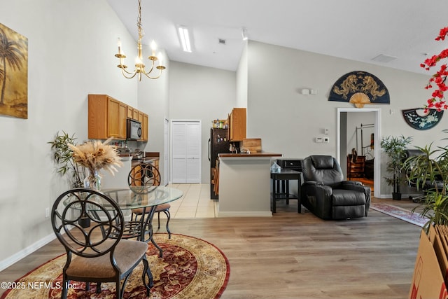 3671 Kirkpatrick Cir Unit 14, Jacksonville, FL 32210 - dining room featuring light wood-type flooring, a notable chandelier, visible vents, and high vaulted ceiling