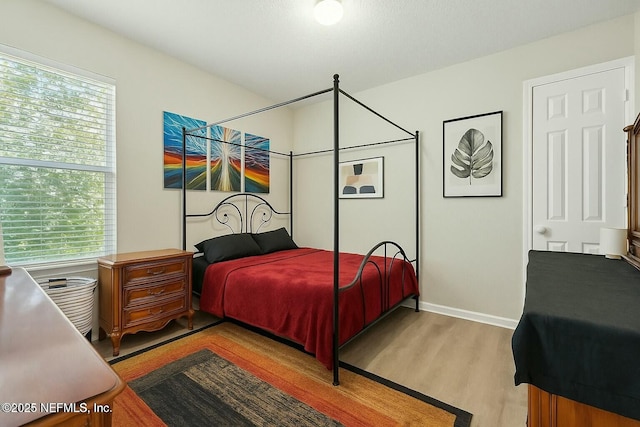 3671 Kirkpatrick Cir Unit 14, Jacksonville, FL 32210 - bedroom with baseboards, multiple windows, and wood finished floors