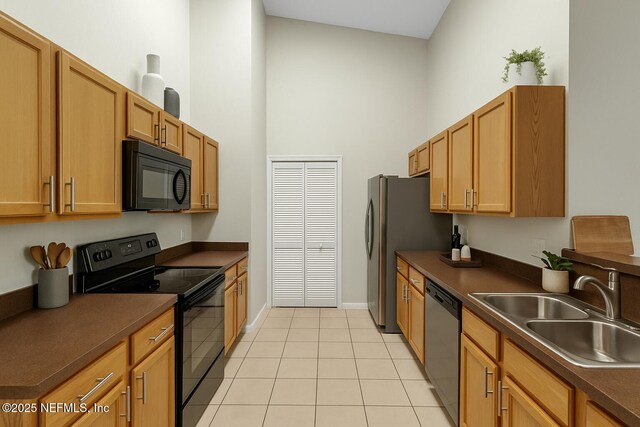 3671 Kirkpatrick Cir Unit 14, Jacksonville, FL 32210 - kitchen with a sink, light tile patterned flooring, black appliances, a high ceiling, and dark countertops