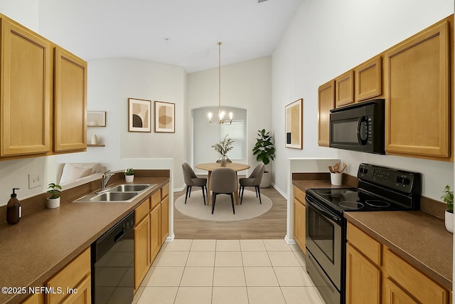 3671 Kirkpatrick Cir Unit 14, Jacksonville, FL 32210 - kitchen with light tile patterned floors, a sink, a chandelier, black appliances, and dark countertops
