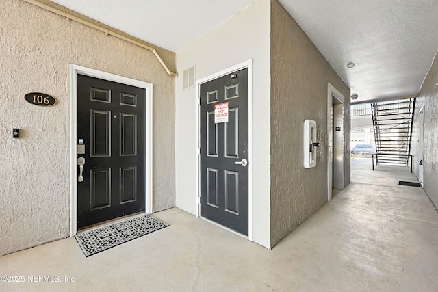 115 Legendary Dr Unit 106, Saint Augustine, FL 32902 - view of exterior entry featuring visible vents and stucco siding