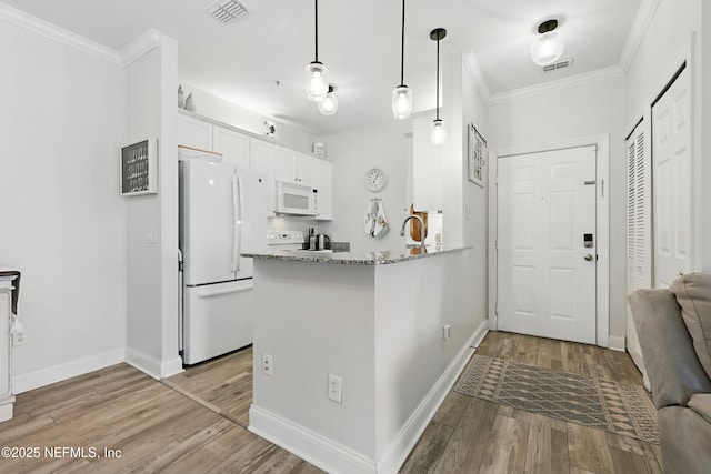 115 Legendary Dr Unit 106, Saint Augustine, FL 32902 - kitchen with ornamental molding, white appliances, white cabinetry, and visible vents