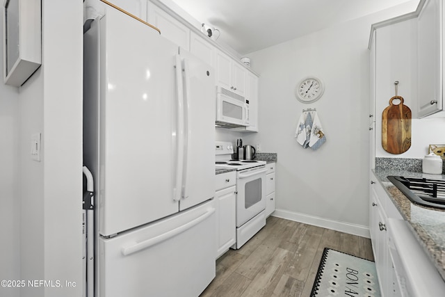 115 Legendary Dr Unit 106, Saint Augustine, FL 32902 - kitchen with white appliances, white cabinetry, baseboards, and light wood-style flooring
